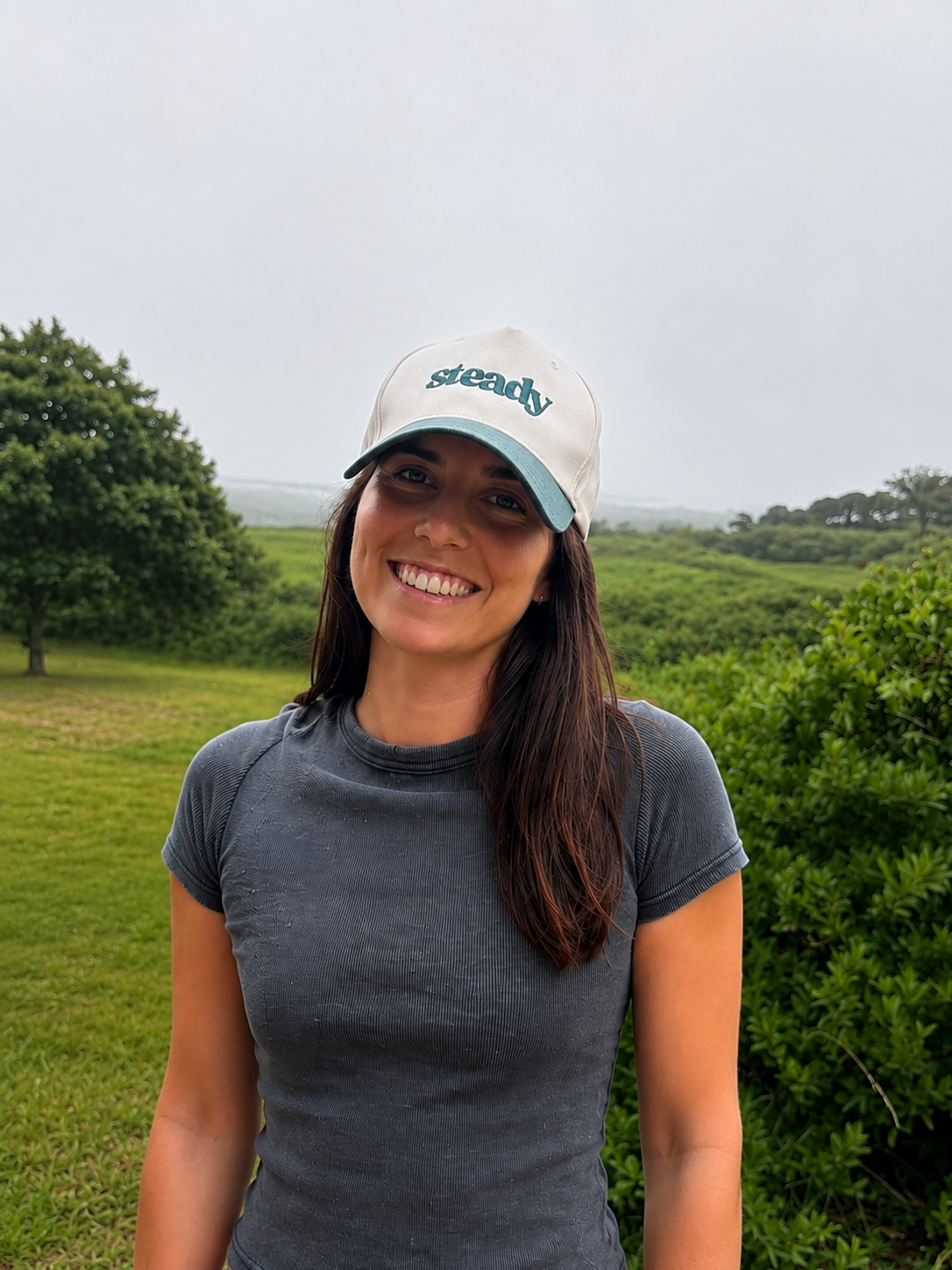 Person wearing the Steady Trucker Hat outdoors.